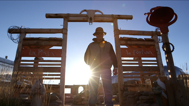 Michael Ruppert in corral, backlit by sun